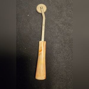 Brass Pattern Wheel with Marbled Amber Handle